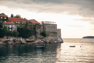 View of the sea and the island of Sveti Stefan on the background of the sunset in Montenegro. This...