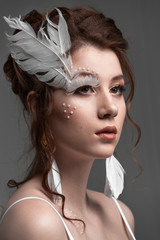 Elegant and gorgeous stylish model. Studio fashion and beauty portrait. Art concept. White swan or angel idea.
