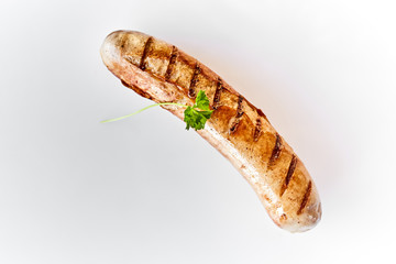 Single juicy grilled or barbecued pork sausage
