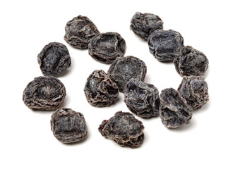 Dried black plums isolated on white background