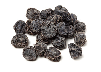 Dried black plums isolated on white background