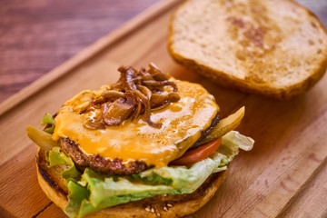 Delicious cheeseburger on the wooden table