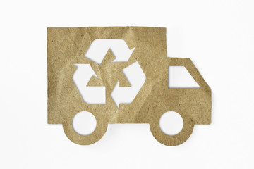 Recycled paper cut of truck with recycling symbol on white background - Green transportation concept
