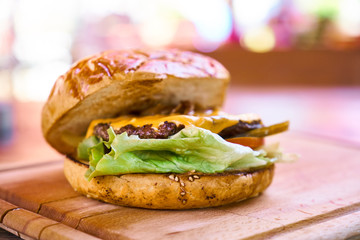 Delicious cheeseburger on the wooden table