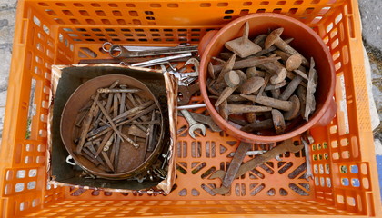  Old rusty nails and hand tools  in a orange plastic box