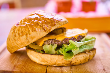 Delicious cheeseburger on the wooden table