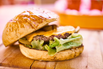 Delicious cheeseburger on the wooden table
