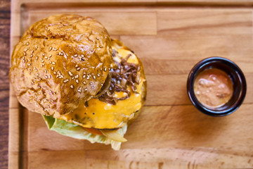 Delicious cheeseburger on the wooden table