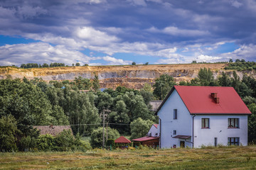 View on the house with porphyry mine on background in Zalas, small village near Cracow, Poland