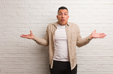 Young latin man confused and doubtful
