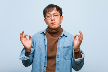Young chinese man performing yoga