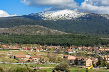 Fototapeta na wymiar Village of Valsain and mountain Peñalara the highest in the Sierra de Guadarrama limit of the provinces of Madrid and Segovia in Spain.