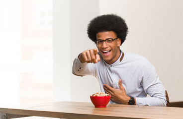 Fototapeta na wymiar Young black man having a breakfast dreams of achieving goals and purposes