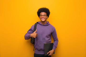 Young african american student man smiling and raising thumb up