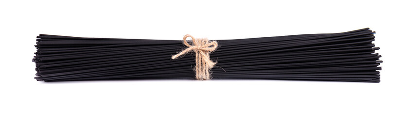 Black spaghetti with squid ink, isolated on white background. Pasta with black cuttlefish ink.