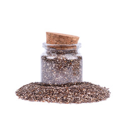 Chia seeds in glass jar, isolated on white background. Healthy superfood. Closeup macro of small organic chia seeds.