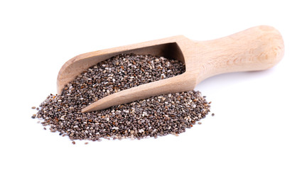 Chia seeds in wooden spoon, isolated on white background. Healthy superfood. Closeup macro of small organic chia seeds.
