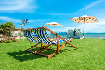lounge chairs with sun umbrella on a beach