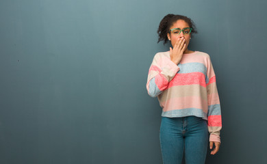 Young african american girl with blue eyes tired and very sleepy