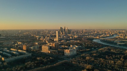 Obraz premium Aerial view of Moscow city glass skyscrapers and Moscow river. Cars driving on the motorway. Sunny, blue sky, spring. Russia. Modern. Urban.
