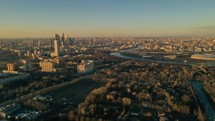 Obraz premium Aerial view of Moscow city glass skyscrapers and Moscow river. Cars driving on the motorway. Sunny, blue sky, spring. Russia. Modern. Urban.