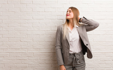 Young russian business woman suffering neck pain