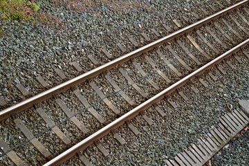 Naklejka premium old train tracks in the station in the street