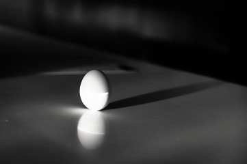 an egg standing vertical on it's bottom in the ray of light