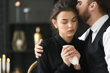 Couple pining after their relative at funeral