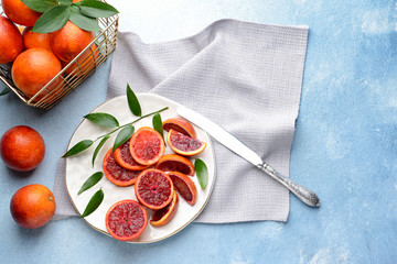 Fresh blood oranges on color table