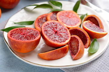 Fresh blood oranges on plate