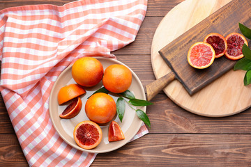 Fresh blood oranges on wooden table