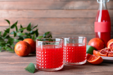Glasses of fresh blood orange juice on wooden table