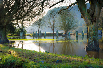 Standing Stone Circle on a flooded field with trees Conwy Valley Wales UK