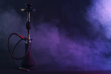 Hookah with fume on dark background