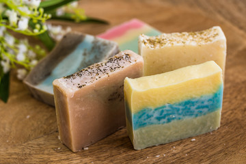 colorful natural handmade soaps on wooden table