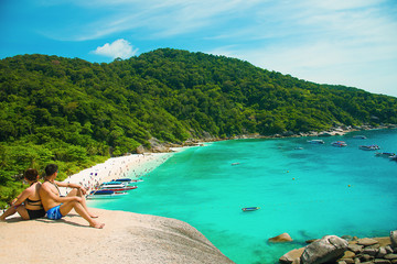 Romantic scene of young love couple sitting with relaxing and happiness on the beach in Similan islands in Andaman sea at  Phuket in southern of Thailand. - Image