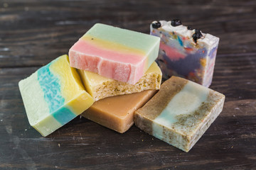 handmade soaps on dark wooden background