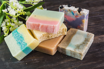 handmade soaps on dark wooden background