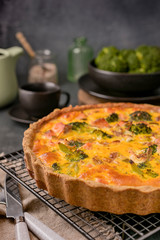 Traditional broccoli pie with salmon and cheese. Food from healthy and healthy foods. Lunch. Photo in the style of dark.
