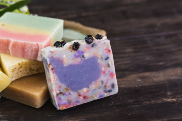 handmade soaps on dark wooden background