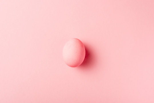 top view of painted easter egg on pink surface
