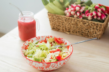 Fresh vegetable salad and a glass with smoothies. The concept of proper nutrition, healthy breakfast.