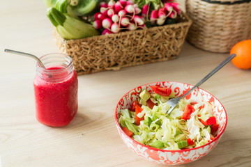Fresh vegetable salad and a glass with smoothies. The concept of proper nutrition, healthy breakfast.