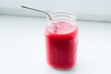 A glass with red berry smoothie. The concept of proper nutrition, healthy breakfast.