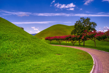 Vertical conceptual view of a hill and sky with clouds in the Gyeongju Tumuli Park