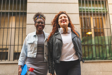 Two Teenage Latin Girls Walking Together in the Street.