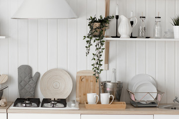 Modern new light interior of kitchen with white furniture.