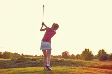 Fotobehang Beauty Cheerful Young Adult Girl Playing Golf at Sunset Beautiful Golf Course © CDPiC