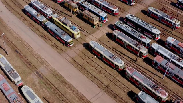Aerial view of tram depo with many old trams.